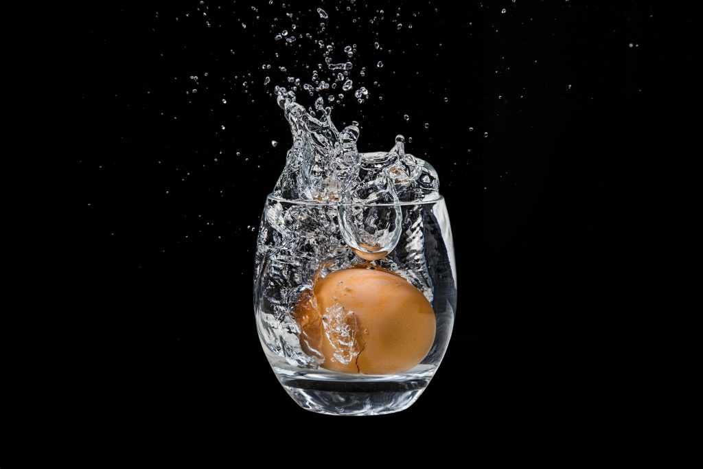 Egg dropped in glass of water